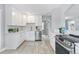 Modern white kitchen with stainless steel appliances at 4424 Decatur St, Denver, CO 80211