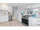 Modern white kitchen with stainless steel appliances at 4424 Decatur St, Denver, CO 80211