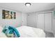 Bright bedroom with a double bed, teal pillows, and closet at 4424 Decatur St, Denver, CO 80211