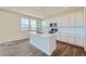 Modern kitchen with white cabinets, quartz countertops, and island at 1231 Loraine N Cir, Lafayette, CO 80026