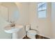 Modern powder room with pedestal sink and updated fixtures at 1231 Loraine N Cir, Lafayette, CO 80026