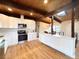 Modern kitchen with white cabinets and stainless steel appliances at 6352 Kendall St, Arvada, CO 80003