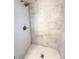 Clean shower with penny round tile flooring at 6352 Kendall St, Arvada, CO 80003