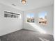 Spacious bedroom featuring grey carpet and multiple windows at 5282 Columbine Ln, Denver, CO 80221