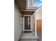 Modern house entrance with dark door, gray siding, and a small covered porch at 5282 Columbine Ln, Denver, CO 80221