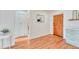 Bright entryway with wood-look floors, coat closet, and access to kitchen at 1150 Golden Cir # 205, Golden, CO 80401