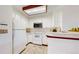 Clean white kitchen featuring built-in microwave and stove at 8116 Gray Ct # 482, Arvada, CO 80003