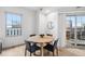 Bright dining area with a round table and four chairs near balcony access at 925 N Lincoln St # 6F, Denver, CO 80203