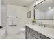 Modern bathroom with a white tub, gray vanity and marble countertop at 1304 Snowberry Ln # 102, Louisville, CO 80027