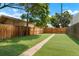 Landscaped backyard featuring a grassy lawn and walkway at 756 Inca St, Denver, CO 80204