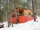 Rustic log cabin on a hillside with snowy surroundings at 5525 S Twin Spruce Dr, Evergreen, CO 80439