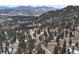 Aerial view of property showcasing mountainous landscape and road access at 5525 S Twin Spruce Dr, Evergreen, CO 80439