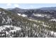 Aerial view of home with mountain and forest views at 5525 S Twin Spruce Dr, Evergreen, CO 80439