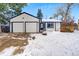 Charming ranch home with a two-car garage and snowy front yard at 7341 S Quarry Mountain Rd, Littleton, CO 80127