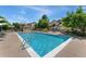 Community swimming pool with lounge chairs at 8623 E Dry Creek Rd # 423, Englewood, CO 80112