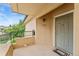 Exterior entrance with private balcony and green door at 8623 E Dry Creek Rd # 423, Englewood, CO 80112