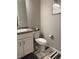 Clean bathroom with white vanity, grey tile, and modern fixtures at 12261 Karls Ln, Northglenn, CO 80241