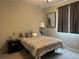 Spacious bedroom with a queen-sized bed and large window at 12261 Karls Ln, Northglenn, CO 80241