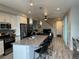Open concept kitchen with island, stainless steel appliances, and grey countertops at 12261 Karls Ln, Northglenn, CO 80241