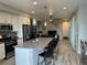 Open concept kitchen with island, stainless steel appliances, and grey countertops at 12261 Karls Ln, Northglenn, CO 80241