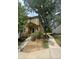 Two-story tan home with a front porch, steps, and landscaping at 1514 S Buckley Way, Aurora, CO 80017