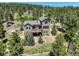 Two-story home with deck nestled in a wooded area at 1055 Divide View Dr, Golden, CO 80403