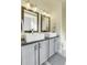 Double vanity bathroom with granite countertops and gray cabinets at 1195 Briarhollow Way, Highlands Ranch, CO 80129