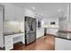 Modern kitchen with white cabinets, granite counters, and stainless steel appliances at 1195 Briarhollow Way, Highlands Ranch, CO 80129