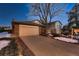 Evening view of the home's exterior, including the driveway and landscaping at 2874 S Ursula Ct, Aurora, CO 80014