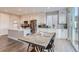Modern kitchen with white cabinets, stainless steel appliances, and an island at 6645 Dry Fork Dr, Frederick, CO 80516