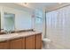 Clean bathroom with single sink and a ruffled shower curtain at 6645 Dry Fork Dr, Frederick, CO 80516