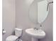 Simple, clean bathroom with pedestal sink and oval mirror at 6645 Dry Fork Dr, Frederick, CO 80516