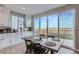 Modern kitchen with white cabinets and a dining table by the sliding door at 6645 Dry Fork Dr, Frederick, CO 80516