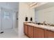 Bathroom with double vanity, shower, and linen closet at 6645 Dry Fork Dr, Frederick, CO 80516