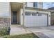 Front entrance with stone accents and a large gray door at 6645 Dry Fork Dr, Frederick, CO 80516