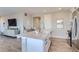 Open concept kitchen with island and white cabinetry at 6645 Dry Fork Dr, Frederick, CO 80516
