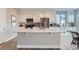 Modern kitchen with white cabinets, stainless steel appliances, and an island at 6645 Dry Fork Dr, Frederick, CO 80516