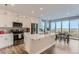 Bright kitchen with island, stainless steel appliances, and view at 6645 Dry Fork Dr, Frederick, CO 80516