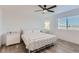 Bright bedroom with ceiling fan, large bed, and window at 6645 Dry Fork Dr, Frederick, CO 80516