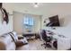 Home office with desk, keyboard, and comfortable couch at 6645 Dry Fork Dr, Frederick, CO 80516
