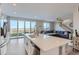 Spacious kitchen with island, stainless steel appliances, and living room view at 6645 Dry Fork Dr, Frederick, CO 80516