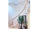 Elegant curved staircase with hardwood flooring and a large chandelier at 14248 E Hampden Ave, Aurora, CO 80014