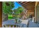 Spacious patio with table and chairs, overlooking a green space at 14248 E Hampden Ave, Aurora, CO 80014