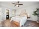 Spacious bedroom with wood-look floors and ensuite bathroom at 2105 Coronado Pkwy # C, Denver, CO 80229