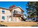 Tan two-story home with deck, stairs, and grassy yard at 2105 Coronado Pkwy # C, Denver, CO 80229