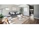 Bright living room featuring a gray couch and wood floors at 2105 Coronado Pkwy # C, Denver, CO 80229
