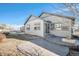 Inviting backyard patio with a built-in fire pit and fenced yard at 7285 S Titus Way, Aurora, CO 80016