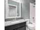 Bathroom featuring a dark vanity with a light countertop and white tile shower at 7285 S Titus Way, Aurora, CO 80016