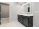 Modern bathroom with double sink vanity and tile floor at 7285 S Titus Way, Aurora, CO 80016