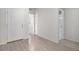 Bright entryway with wood-look flooring and access to a nearby bathroom at 7285 S Titus Way, Aurora, CO 80016